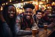 A young African man sitting in company of friends in bar on weekend