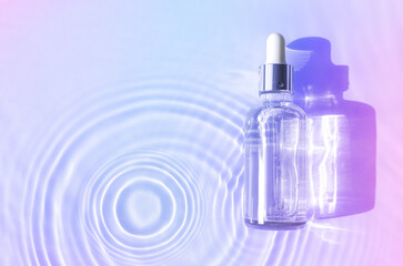 Wall Mural - serum bottle in water with splashes and waves