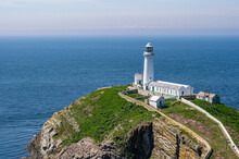 South Stack Lighthouse On The West Coast Of Anglesey In Wales, Reached By A Long, Steep Flight Of Stone Steps.  The Day Is Bright And Sunny