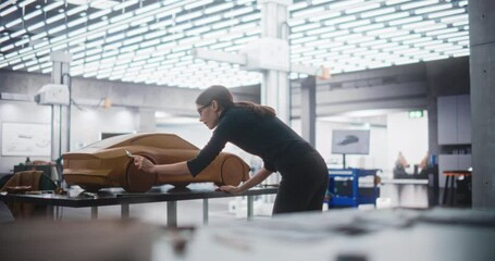 Wall Mural - Portrait of a Young Automotive Artist Making Final Strokes on Her Latest Concept Car Creation. Female Designer Working on a Prototype, Sculpting Industrial Plasticine Clay 3D Model of a Sport Coupe