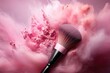 A pink and light brown powder makeup brush applies powder to create a colorful cloud.