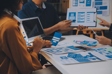 Close up ux developer and ui designer use augmented reality brainstorming about mobile app interface wireframe design on desk at modern office.Creative digital development agency