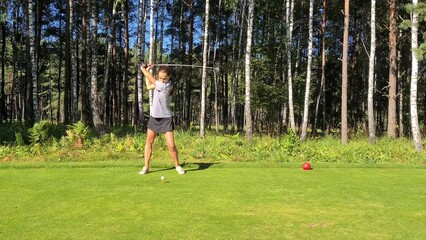 Wall Mural - Professional female golfer in sportswear plays golf at golf practice tournament on course. Playing golf