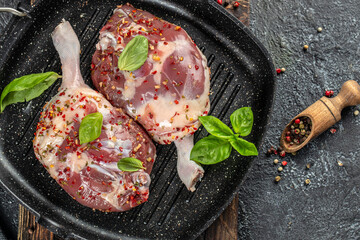 Canvas Print - Fresh duck leg meat on a dark background. top view. copy space for text