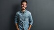 © WS Studio 1985 - Confidence and business concept. Portrait of charming successful young entrepreneur in blue-collar shirt, smiling broadly with self-assured expression while holding hands in pockets over gray