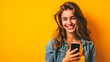 beautiful young smiling happy woman holding smartphone in a studio 