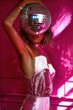 © okey.kat - Young woman in pink party dress with disco ball sphere. New year, birthday, christmas party. Glitter, shiny cloth. Fashion shot. Ai generated photography
