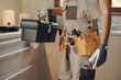 © Daria - Close up of repairman in uniform standing on home kitchen and holding his tool bag