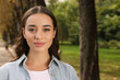 © New Africa - Portrait of beautiful young woman in park. Space for text