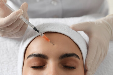 Canvas Print - Doctor giving facial injection to young woman in clinic, closeup. Cosmetic surgery