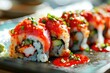 Spicy tuna sushi roll garnished with fiery red sauce