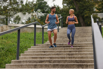 Sticker - Healthy lifestyle. Happy couple running down stairs outdoors