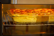 Apple pie in an electric oven with backlight