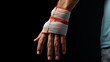 A hand with a bandage wrapped around the wrist area, a typical response to wrist injuries to aid healing and restrict movement.