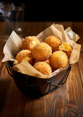 Wall Mural - Closeup of Brazilian Deep fried Cheese balls on the wooden table