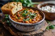 A bowl of pinto beans is paired with a slice of bread
