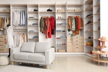 Poster - Interior of boutique with stylish clothes and sofa