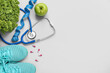 © Pixel-Shot - Composition with stethoscope, measuring tape, pills and healthy food on grey background