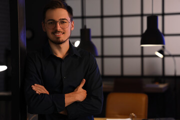 Wall Mural - Handsome young man in office at night