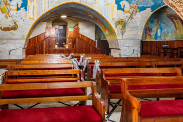 Wall Mural - Wooden benches in main hall of the Greek Orthodox Church of Annunciation in Nazareth old city in northern Israel