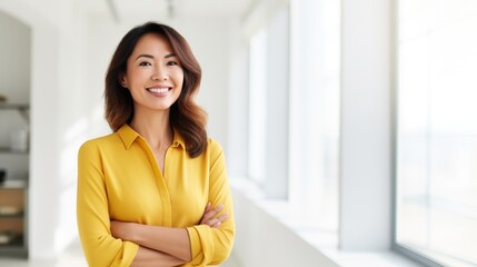 Wall Mural - Smiling mid aged mature professional business woman in ginger yellow blouse, 40s female executive or entrepreneur holding fintech tab digital tablet standing in office at work, large window copy space