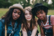© eshana_blue - Beautiful multiracial teens taking a photo in the park together, African boys wearing cool stylish hats and caucasian girl between them.