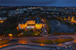 © mark_gusev - Aerial view on Salthill area of Galway city, Ireland. Night scene with illuminated roads, buildings and city lights and dark sky and ocean. Stunning town view. Warm and cold color toning.