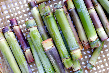 Wall Mural - Fresh sugar cane on bamboo weave plate