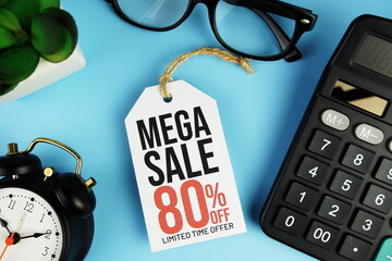 Wall Mural - Top view of Mega Sale 80% text on tag sale with calculator and black alarm clock flat lay on blue background