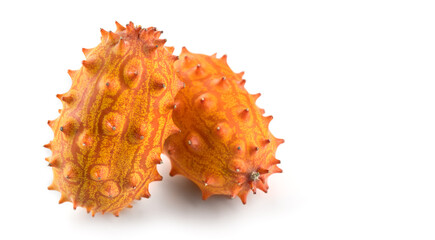 Canvas Print - Kiwano fruit or Horned melon close up. Fresh and juicy African horned cucumber or jelly melon, hedged gourd liana whole exotic fruits closeup, isolated on white background