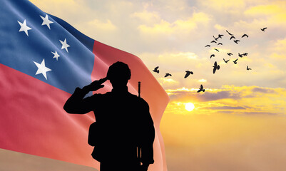 Silhouette of a soldier with the Samoa flag stands against the background of a sunset or sunrise. Concept of national holidays. Commemoration Day.