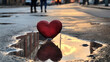 A close-up shot of a couple's reflection in a heart-shaped puddle, representing the reflection of love and togetherness on Valentine's Day.