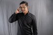 © Taufiq - Asian businessman who looks dizzy because he thinks about his business and finances