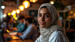© Valeriia - Muslim woman freelances at cafe, working on laptop peacefully.