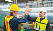© lovelyday12 - Engineers shake hands after completing work in a heavy machinery factory