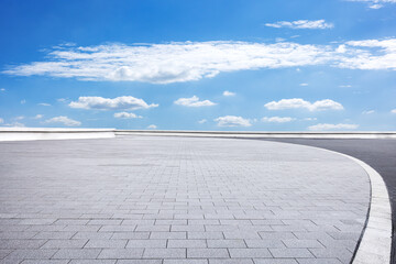 Wall Mural - Empty brick floor and sky clouds background