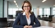 In this engaging portrait, a competent and amiable executive businesswoman, sporting glasses, radiates intelligence and friendliness as she assumes the roles of manager, advisor, agent, and representa