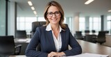 Fototapeta  - In this engaging portrait, a competent and amiable executive businesswoman, sporting glasses, radiates intelligence and friendliness as she assumes the roles of manager, advisor, agent, and representa