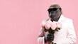 © ds17 - Monkey in a suit with a bouquet of roses on a pink background