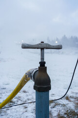 Close-up of the water supply handle for snow cannons