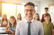 © Adin - Portrait happy confident young man teacher of elementary school kids in classroom, sunlight
