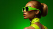 © paffy - Closeup portrait of fashionable woman in green sunglasses and green latex costume, looking to side, on bright studio background
