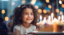 Girl holding  birthday cake with candles.