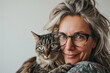 © Lorne Thomson - Senior Woman with Striped Cat Sharing a Tender Moment