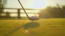 Slow Motion Golf Sport Concept, Golfer Hitting Golf Ball To Hole For Winner In Golf Course Is Beautiful Fairway On Sunset. Close Up Shot Tee Off On Green Grass For Player Playing In Summer For Relax
