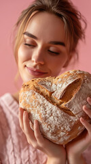 Wall Mural - A beautiful woman is holding bakery bread in the shape of a romantic heart. Valentine's Day food concept