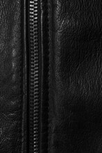 Black Leather Background With Metal Zipper Close-up. Abstract Dark Leather Texture