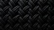  a close up of a black background with a braid of braiding in the middle of the image and a black background with a braid of braid of braiding in the middle.