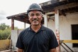 Aged and experienced Hispanic construction foreman worker in a developing area with architecture and infrastructure
