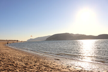 View of the mouth of the Sado River at Tróia Mar Beach, Portugal, with the Serra da Arrábida in the background.